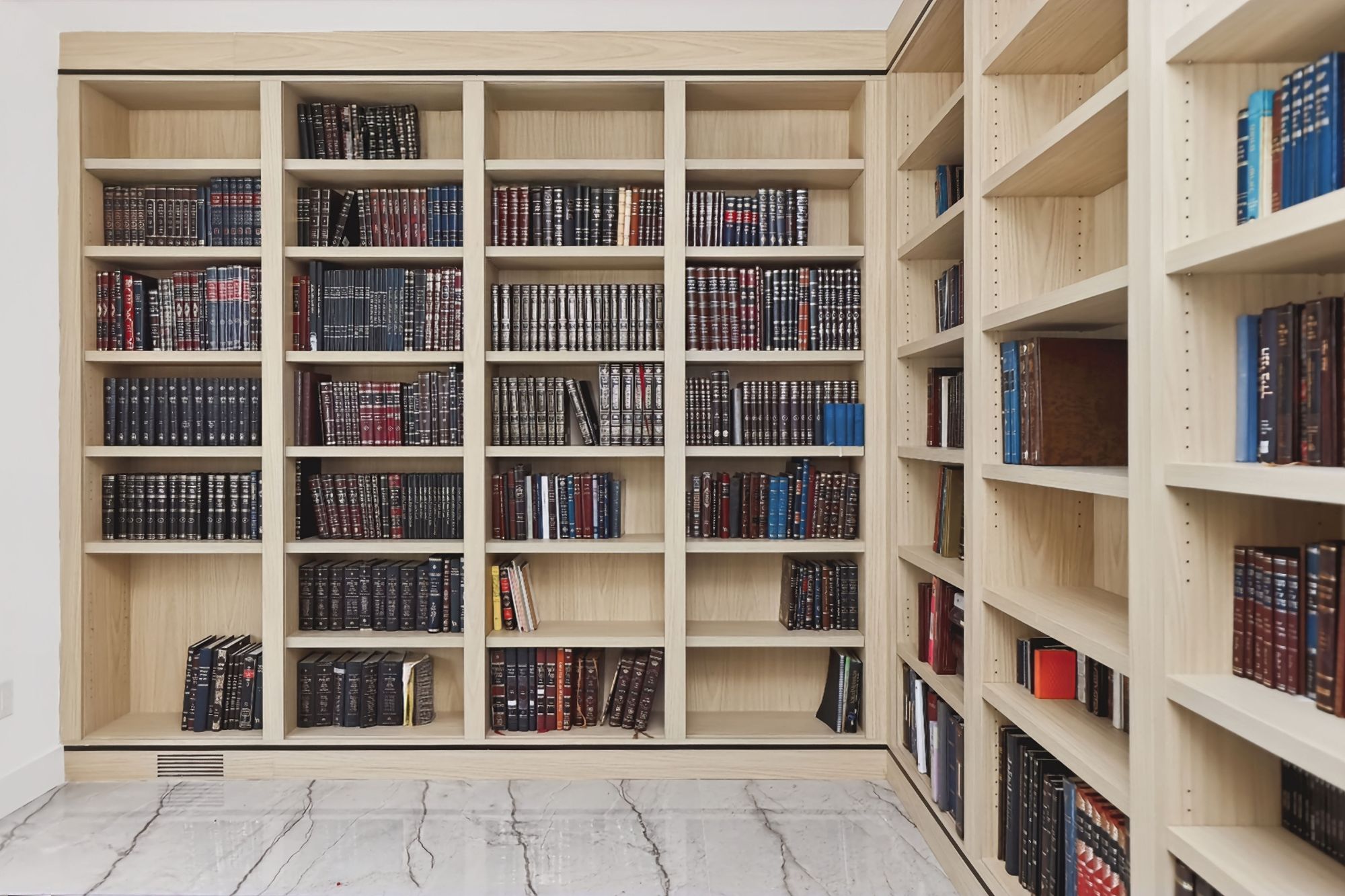 Light oak MelaWood built-in bookcases lining a home study